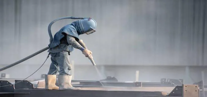 Operator water jetting a surface