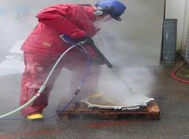 Operator in red coverall water jetting